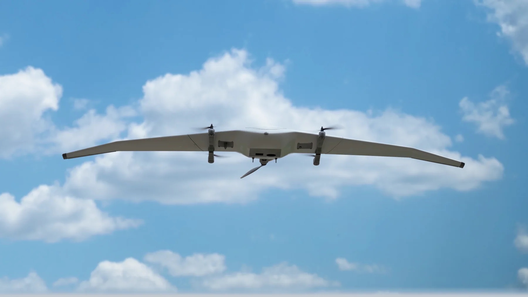 DeltaQuad Evo Tactical fixed-wing VTOL flying against a blue sky